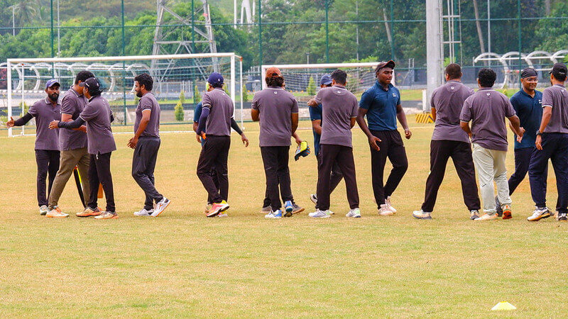 Bat, ball, and a friendly interaction—cricket's all about the game and the camaraderie!
