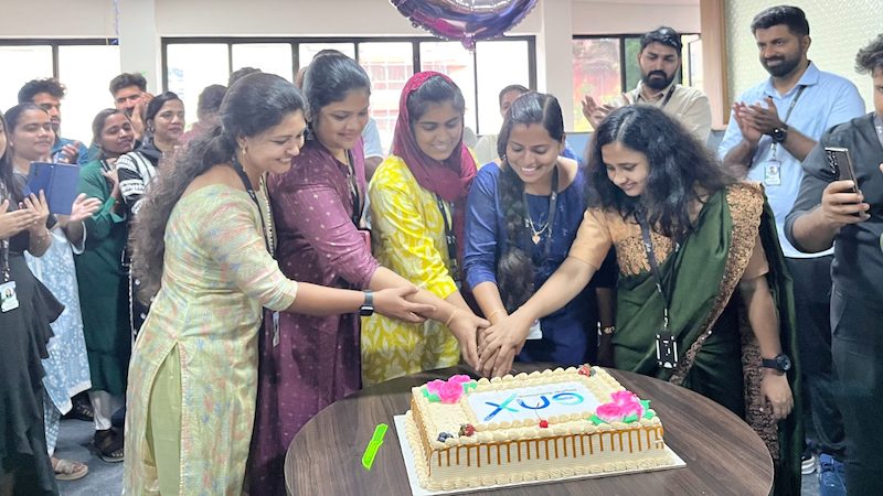 The women staff at GNX cutting the inaugural cake.