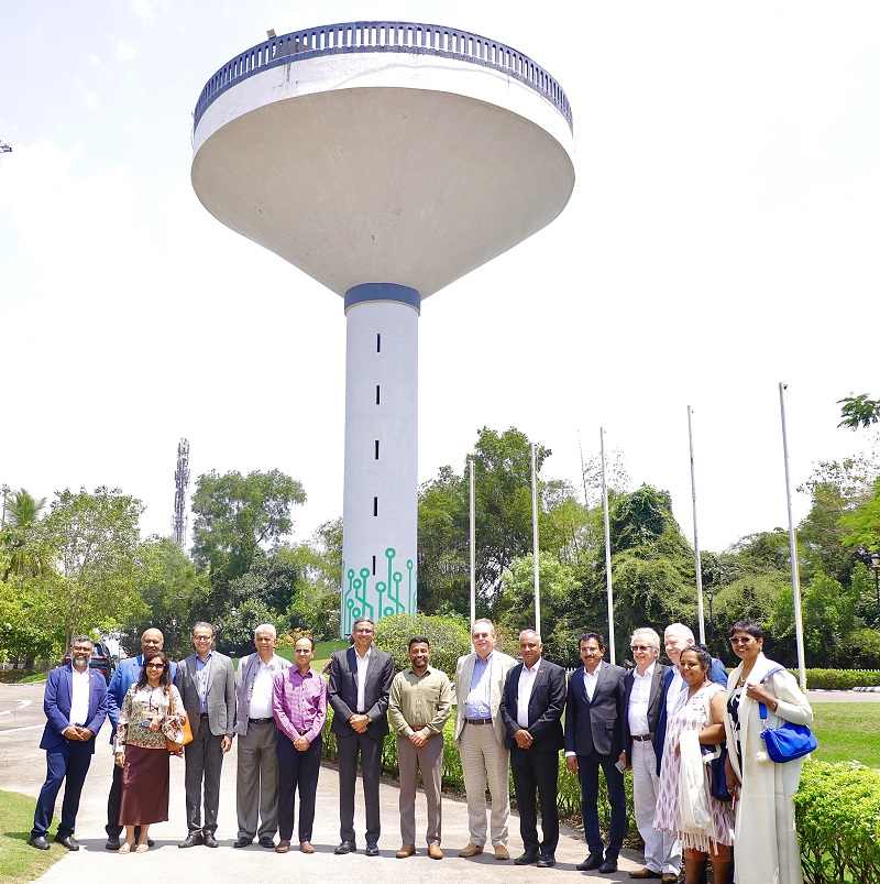 The delegates posing with smiles in front of the iconic Technopark Water Tank.