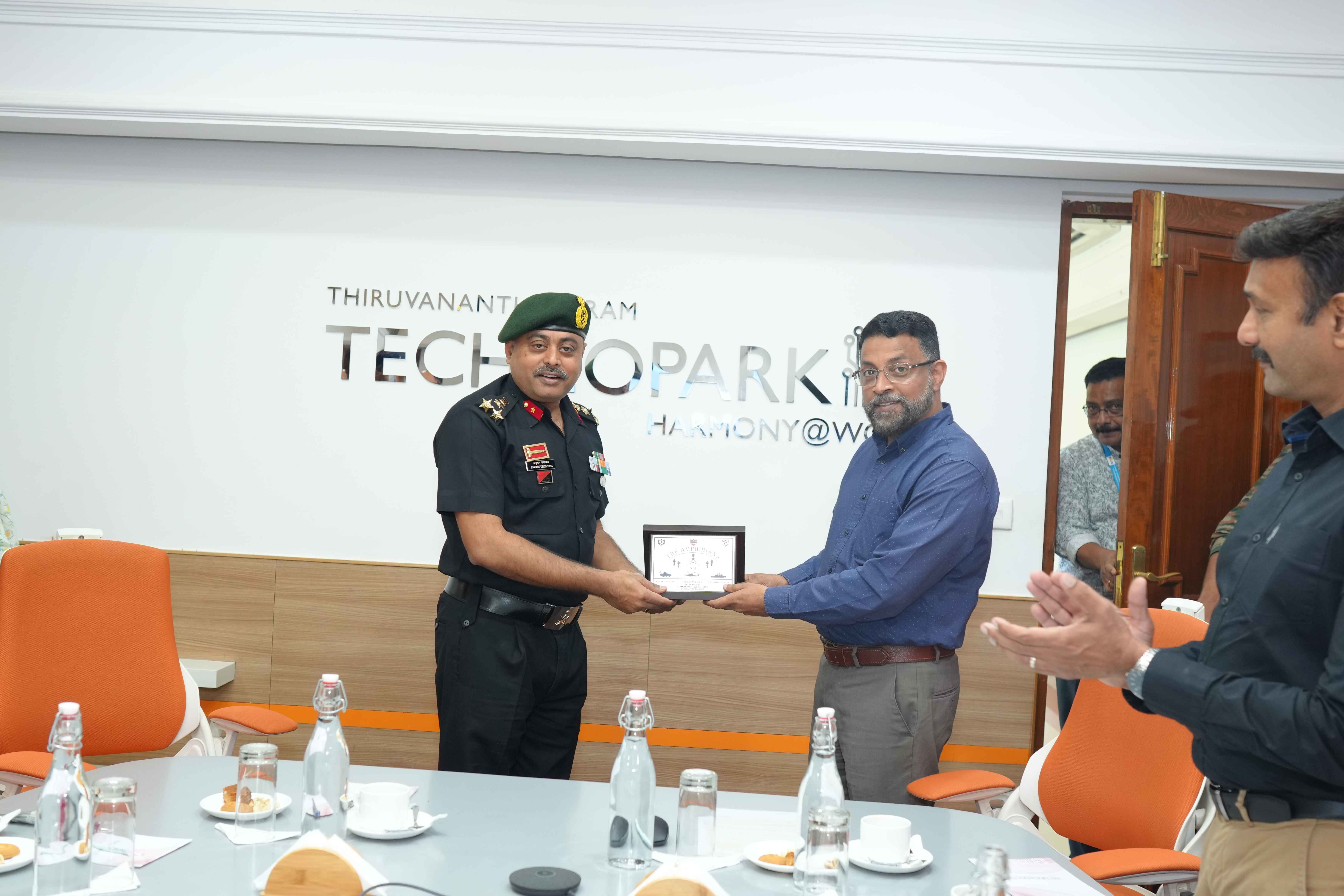 Brigadier Anurag Upadhyaya presenting a token of appreciation to Col Sanjeev Nair (Retd), CEO Technopark.